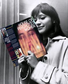 a woman holding up a book in front of her face