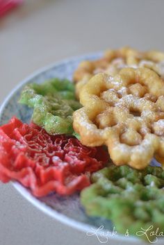 there are four different types of cookies on the plate, and one is made to look like flowers