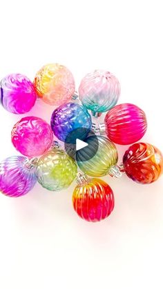 a bunch of colorful glass balls sitting on top of each other