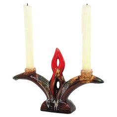 two candles are sitting on top of each other with one candle in the middle and another burning