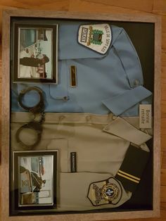 a police uniform and other items are displayed in a shadow box