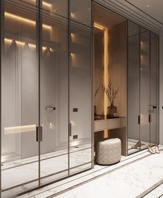 the interior of a modern bathroom with mirrored walls and marble flooring is lit by recessed lighting