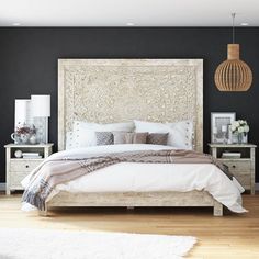 a bedroom with black walls and white furniture