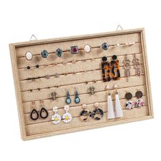 a wall mounted jewelry rack with earrings