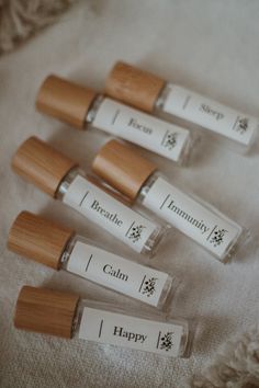 four lip bales sitting on top of a white cloth covered tablecloth next to each other