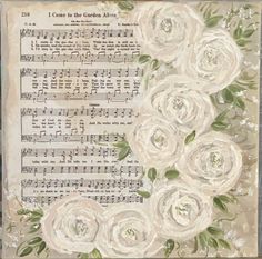 an old sheet music with white roses on it