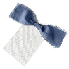 a blue and white bow tie on top of a piece of paper with torn edges