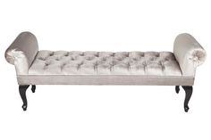 an upholstered chaise lounge with buttons on the back