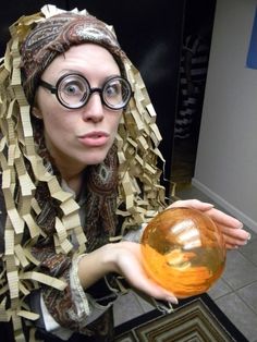 a woman wearing glasses holding an orange ball