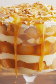 a layered cake with caramel sauce drizzled over it's top