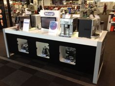 there are many coffee machines on display in the store