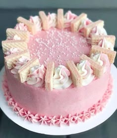 a cake with pink frosting and white icing