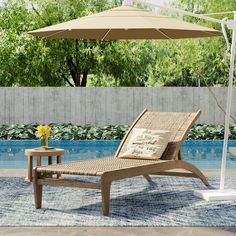 an outdoor lounge chair and umbrella next to a swimming pool