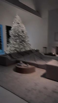 a living room filled with furniture and a christmas tree