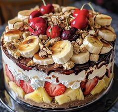 a cake with bananas, strawberries, cherries and walnuts on the top