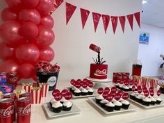 coca - cola themed birthday party with cupcakes, cake and candy on table