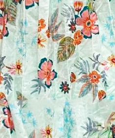 an image of a curtain with flowers and leaves on it's side, close up