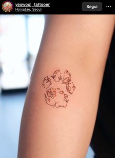 a person with a tattoo on their arm that has cats and dogs in the center