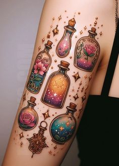 a woman's arm with tattoos on it and some bottles in the shape of stars