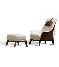 a white chair and ottoman sitting next to each other