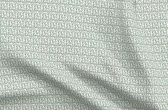 an image of a white and green fabric with small dots on the bottom, as well as