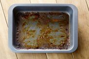 a pan filled with food sitting on top of a wooden table