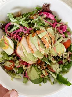 a white bowl filled with green goddess salad