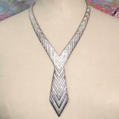 "Rare 1970s silver necklace formed into the shape of a tie. The necklace has an interesting chevron design throughout. Jewellery of the 1970s was bold and beautiful with a hint of decadence - summed up perfectly in this usual necklace. Paired with a shirt or a dress this necklace will make a strong statement. Details Length: circumference of necklace part; 45 cm; length of \"tie\" drop 9.5cm Weight: 94g Age: 1970s Materials Silver (stamped 925) Condition Notes Good used condition" Peacock Pendant, Silver Tie, Chevron Necklace, Woven Necklace, Tie Necklace, Jewelry Knots, Pearl And Diamond Ring, Solid Gold Necklace, Beaded Drop Earrings