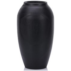 a black vase sitting on top of a white table