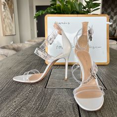 - Designer = Gianvito Rossi - Size = 9.5m(39.5). Trunk 30 - Color = White -4heel Height = Approximately 4.25” Inches - Measured On The Inside From Front Tip Of Open Toe To Back Tip Of Heel To Give An Estimate Of Size Length= Approximately 26.2cm. - Made In Italy - Genuine And Authentic Or Your Money 7back Trunk 30 Evening Sandals With Transparent Straps And Open Heel, Chic Evening Sandals With Transparent Straps, Clear Open Toe Sandals For Wedding, Chic Clear Sandals For Wedding, Designer Clear Heels For Formal Occasions, Glamorous Clear Sandals For Wedding, Chic Clear Wedding Sandals, Party Sandals With Branded Heel Counter, Evening Heels With Transparent Straps