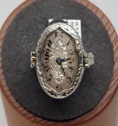 Vintage 18K White Gold Swiss Watch Filigree Ring, Size 4.25, Damaged. Hour hand is partially broken off, crystal has a chip on the side. Ring is stamped BET AIS 18K Pat. Pend. inside band. Watch movement with, 15 Jewels, 3 Adj., Elem. W. Co. Swiss. Watch does not work, balance wheel spins freely but crown won't wind. Back of ring engraved, Bob to Ruth. Ring is 24mm wide. Weighs 3.3 dwt. Are these stones real or fake? Aside from diamonds, we do not know if any gemstones are natural or synthetic. We will state on certain gemstones, that we know 100%, if they are created or fake due to their lack of inclusions. For this reason, we do not sell any diamonds without inclusions, and the larger diamonds (half ct+) are soft graded. In recent years, synthetic gemstones are being created to pass the Work Balance, Balance Wheel, European Jewelry, Vintage Fine Jewelry, Swiss Watch, Star Sapphire, Midi Rings, Filigree Ring, Dream Jewelry