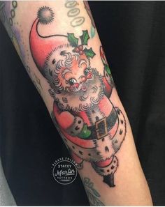 a man with a santa clause tattoo on his arm