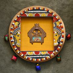 an ornate wooden frame with decorative artwork on the top and bottom, surrounded by small figurines