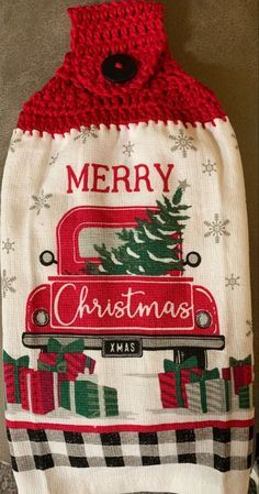 a christmas stocking hanging from the side of a wall with presents on it and a merry truck