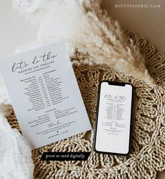 a table with a menu and phone sitting on top of it next to a blanket