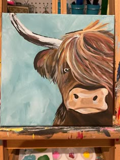 a painting of a brown cow with long hair on it's head is shown