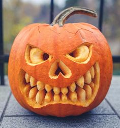 a carved pumpkin with teeth and eyes