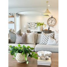 a living room filled with furniture and a large clock on the wall above it's head