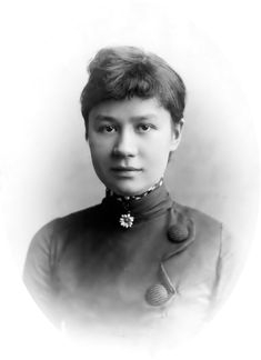 an old black and white photo of a woman wearing a uniform with flowers on her collar