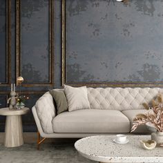 a couch and table in a room with blue wallpaper, gold trimmings