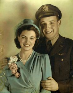 an old black and white photo of a man in uniform standing next to a woman