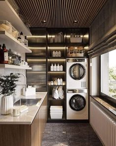 a washer and dryer in a small room next to a window with open shelving