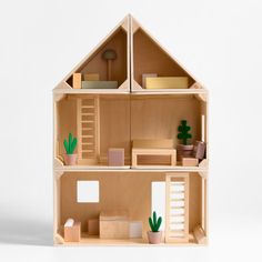 a wooden doll house with furniture and accessories