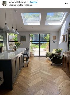 an open kitchen and living room with skylights