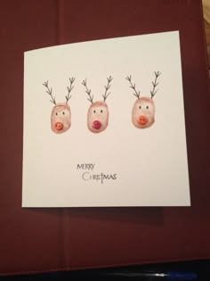 three reindeer heads with antlers on them are drawn in watercolor and then painted onto a card