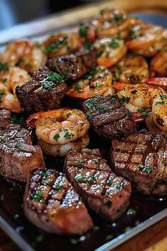 steak and shrimp on a plate with garnish