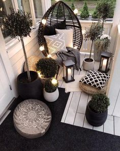 a porch with potted plants and lights