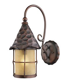 an outdoor light with a metal frame and glass shade