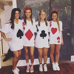 four girls dressed up as playing cards in front of a chalkboard