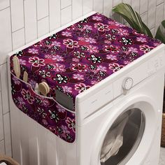 a washer and dryer sitting next to each other in front of a tiled wall